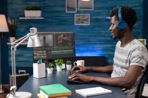 African american videographer editing video montage for visual effects movie