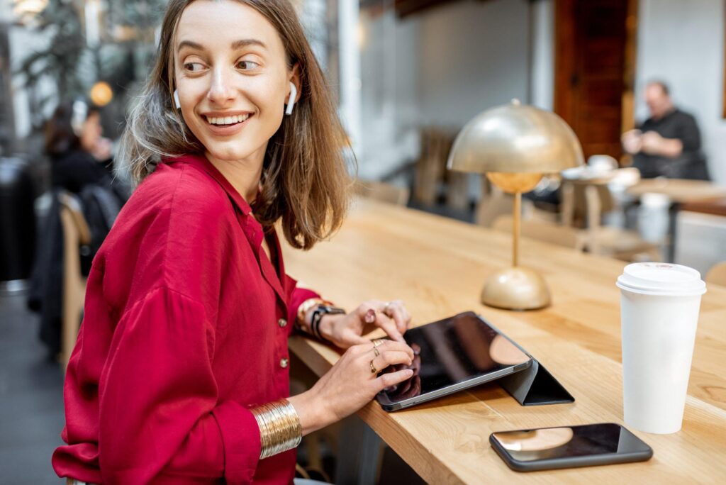 Woman with tablet and mobile phone working indoors